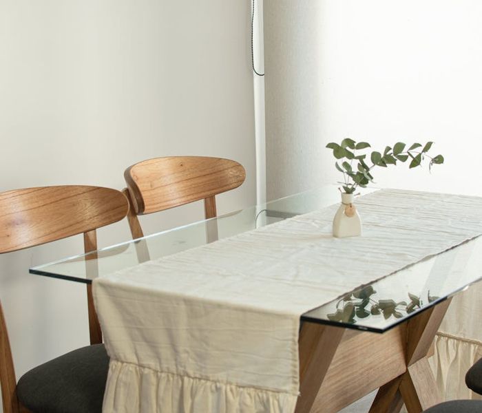A cozy and clean corner of a room with a yoga mat and a plant.